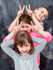 Image showing group of kids standing in front of chalkboard