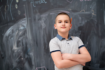 Image showing portrait of little boy in front of chalkboard