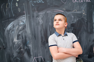 Image showing portrait of little boy in front of chalkboard