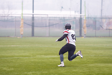 Image showing American football player running on the field