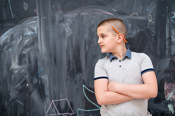 Image showing portrait of little boy in front of chalkboard