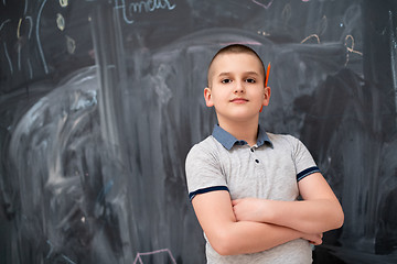 Image showing portrait of little boy in front of chalkboard