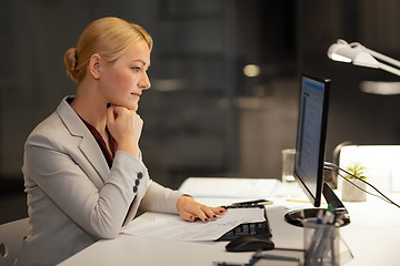 Image showing businesswoman at computer working at night office