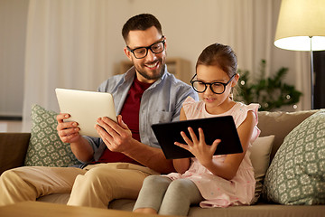 Image showing father and daughter with tablet computers at home