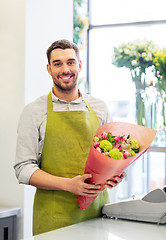 Image showing smiling florist man with bunch at flower shop