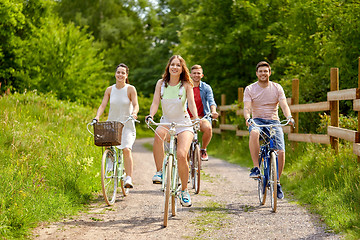 Image showing happy friends riding fixed gear bicycles in summer