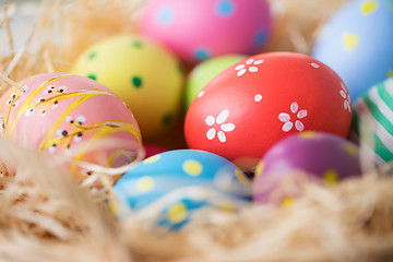 Image showing close up of colored easter eggs in straw