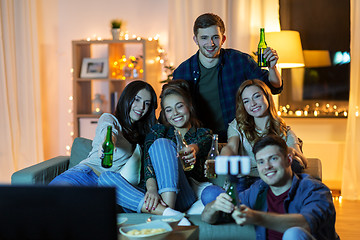 Image showing friends taking picture by selfie stick at home