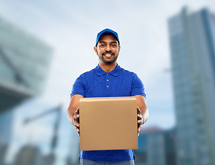 Image showing happy indian delivery man with parcel box in blue