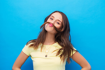 Image showing young woman making mustache with her hair