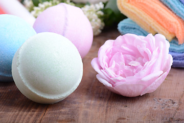 Image showing towels set, aroma therapy, soap and sea salt on wooden plate