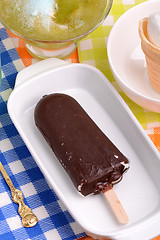 Image showing Chocolate ice cream on white plate and green ice. top view