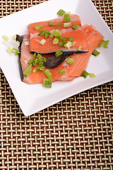 Image showing fresh salmon fillet close up on white plate