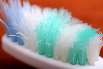 Image showing xtreme Macro close up of toothbrush with wooden background