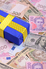 Image showing banknotes, clear image of dollars and new bills Ukrainian national currency hryvnia with gift box