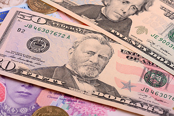 Image showing american dollars and ukrainian grivna pile as background