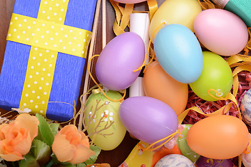 Image showing Arrangement of Gift Boxes in Wrapping Paper with Checkered Ribbons and Decorated Easter Eggs