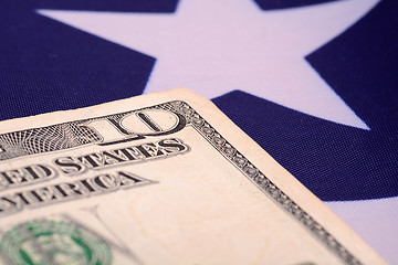 Image showing ten dollar bill in front of the American flag