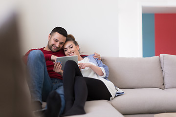 Image showing couple relaxing at  home with tablet computers