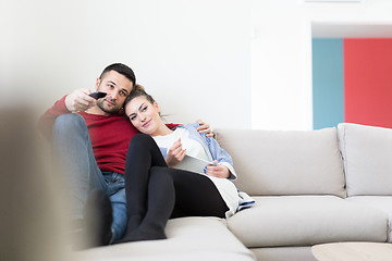 Image showing Young couple on the sofa watching television