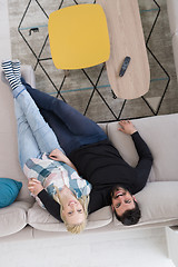 Image showing Young couple on the sofa watching television top view