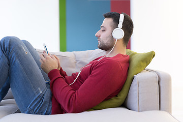 Image showing man enjoying music through headphones