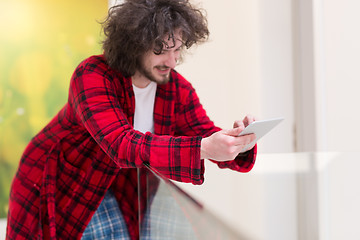 Image showing young freelancer using tablet computer