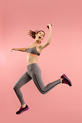 Image showing Full length of pretty young woman with mobile phone while jumping