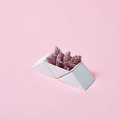 Image showing Composition of paper triangular boxes with cones on a pink background with copy space. Layout for postcard