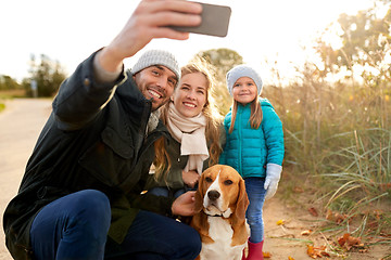 Image showing happy family with dog taking selfie in autumn