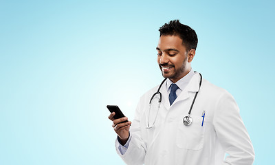 Image showing smiling indian male doctor with smartphone