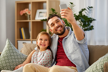 Image showing father and daughter taking selfie at home