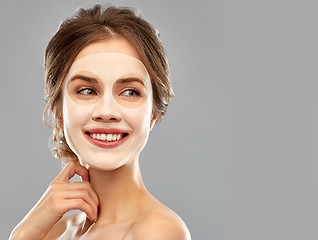 Image showing smiling young woman wearing sheet facial mask