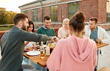 Image showing friends having dinner or rooftop party in summer