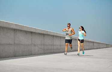 Image showing couple in sports clothes running outdoors