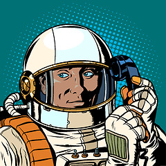 Image showing serious astronaut talking on a retro phone