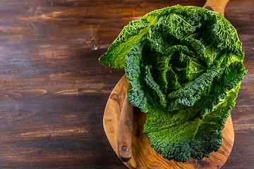 Image showing Fresh raw savoy cabbage on wooden background