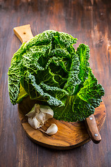 Image showing Fresh raw savoy cabbage on wooden background