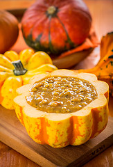 Image showing Red lentils soup with pumpkins served in hollowed pumpkin