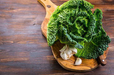 Image showing Fresh raw savoy cabbage on wooden background