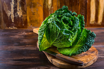 Image showing Fresh raw savoy cabbage on wooden background