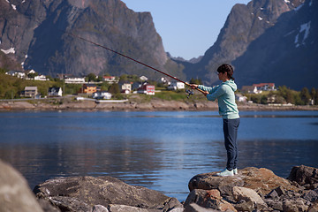 Image showing Woman fishing on Fishing rod spinning in Norway.