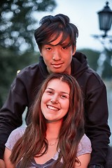 Image showing Smiling young girl and guy at dusk