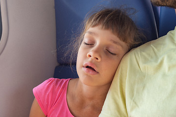 Image showing Girl sleeping leaning on her neighbor\'s shoulder