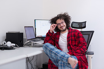 Image showing graphic designer in bathrobe working at home