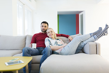 Image showing couple hugging and relaxing on sofa