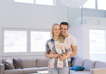 Image showing couple hugging in their new home