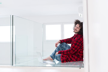 Image showing young freelancer in bathrobe working from home