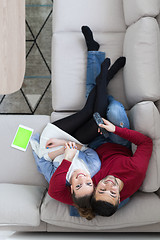 Image showing Young couple on the sofa watching television top view