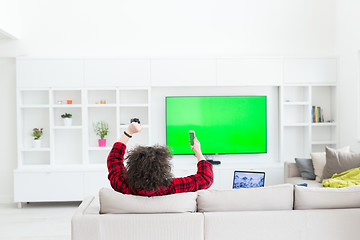 Image showing young man in bathrobe enjoying free time